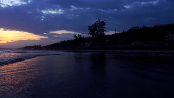 Low angle close to water dramatic cold color sunset on coastline of Mui Ne, Binh Thuan, Vietnam alt