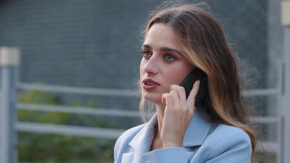 Closeup Young Business Woman Talking Mobile Phone in City Street alt