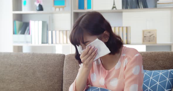Asian young woman feeling itchy nose and sneezing 