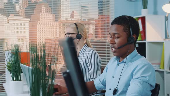 Medium Shot of Friendly African Man Working in Call Center