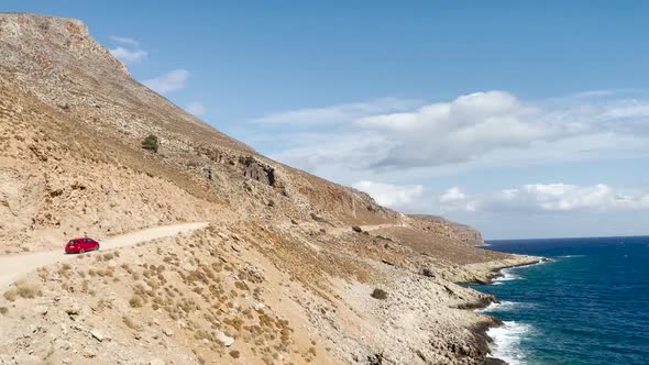 Rocky road to the iconic Balos Beach Lagoon in Crete, Greece. Sea horizon against blue sky alt