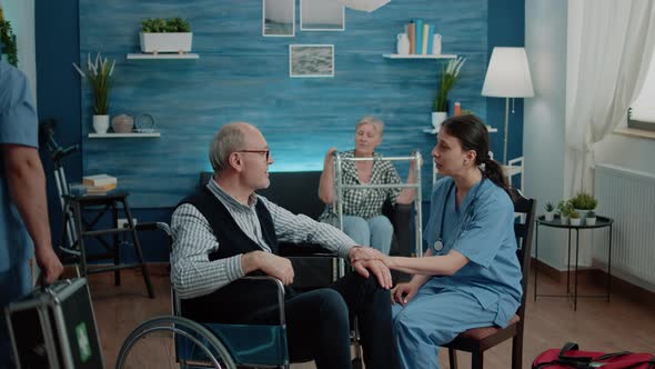 Nurse Giving Assistance to Retired Man with Disability alt