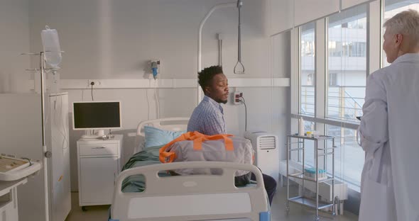 Afroamerican Male Patient Sign Document on Tablet Being Discharged From Hospital alt