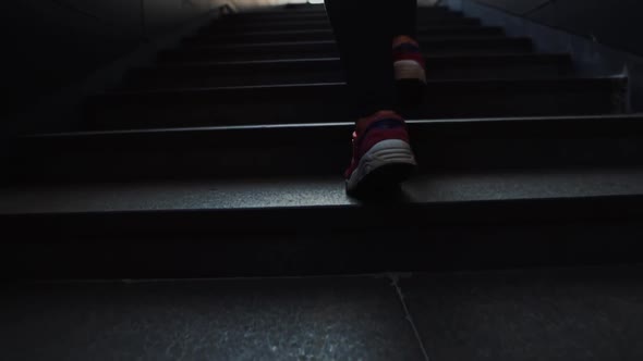Close View of a Young Female Legs in Sport Shoes Running Upstairs on City Stairs