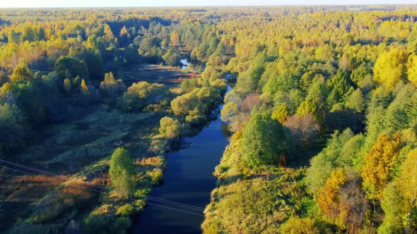 Aerial View of the River Among Forest in the Wild During Fall Season at Sunset