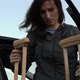 Disabled woman with a broken leg on crutches gets out of the car. - VideoHive Item for Sale