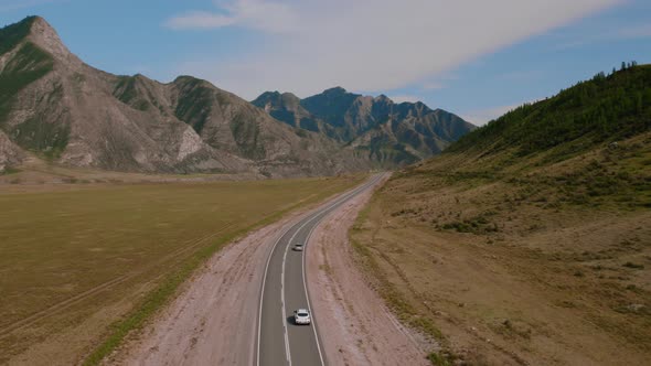 Mountains of Altai with traffic cars on Chuya highway