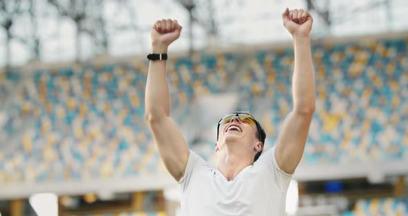 Successful Athlete Raising Hands