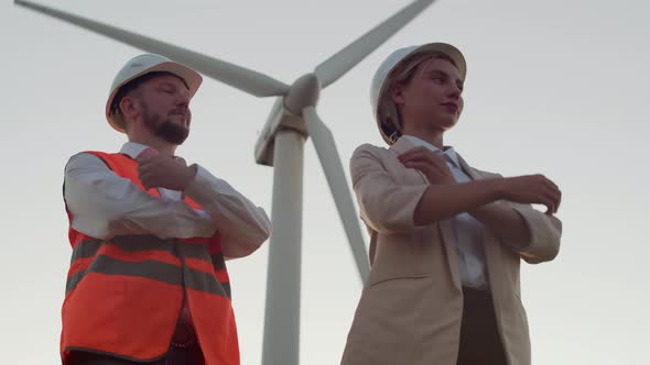 Confident Engineers, a Man and a Woman in Hard Hats Fold Their Arms and Look Confidently  alt
