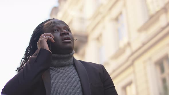 African American Black Man Having Phone Conversation on the City Street alt