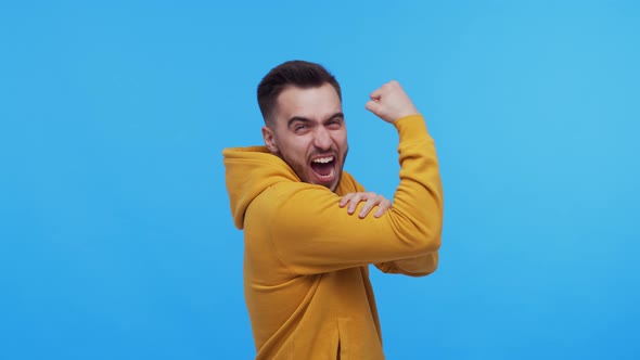 Expressive young man screaming and shouting over vibrant background. alt