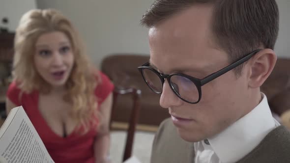 Portrait Cute Modestly Dressed Man in Glasses Reading the Book and Falling Asleep in the Foreground alt