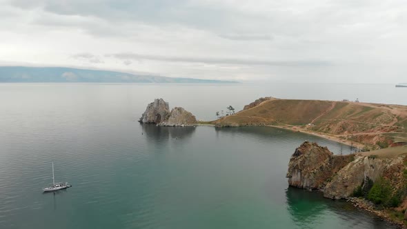 Drone flight over cliff and bay Olkhon Island on Lake Baikal, Russia