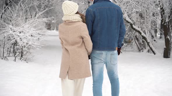 Happy Young Couple in Winter Park having fun.Family Outdoors. Valentine's day alt