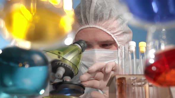 Scientist Looks Through Microscope and Rejoices at the Discovery