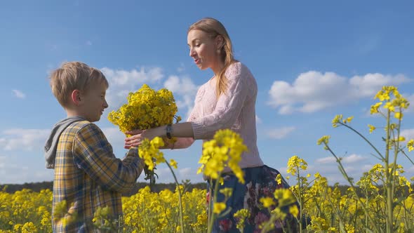 Grateful Son Gives His Mother Flowers Rapeseed Field alt