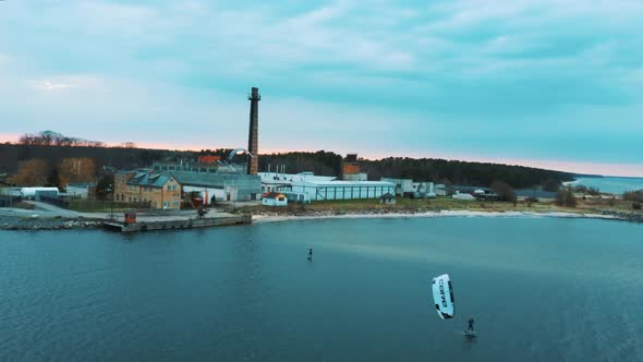 Aerial Drone View of a Corekites Kitesurfers Hydrofoiling  in Engure Port at in Baltic Sea alt
