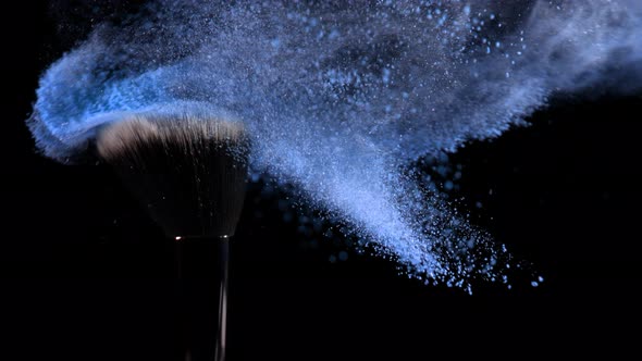 Super Slow Motion Shot of Blue Powder Falling From Facial Brush at 1000Fps alt