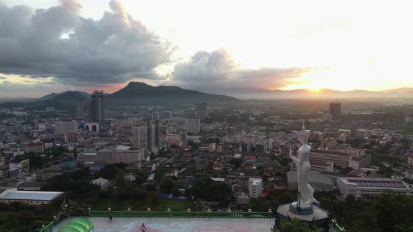 Aerial view drone moving slow motion scene of cityscape with sky sunrise over the mountain.