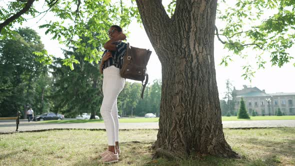 Wide Shot Happy African American Beautiful Young Woman Hanging Backpack on Shoulder Smiling Looking alt