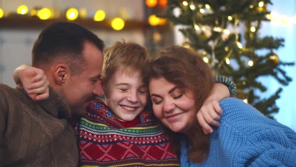 Loving Family with Son on Couch at Christmas Holidays alt