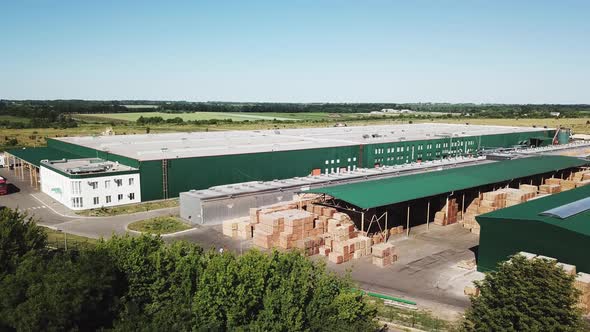 Factory for Manufacturing a Parquet Board is in the Middle of the Field alt