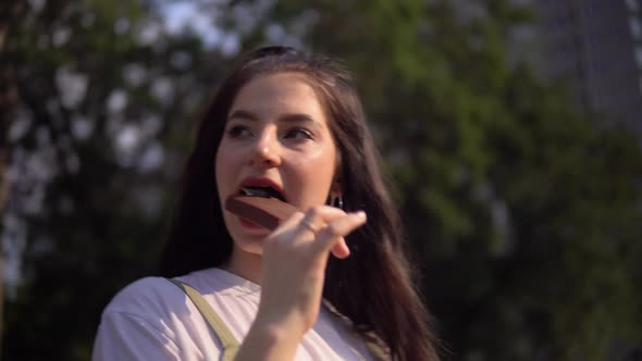 Young Attractive Woman Walking in City Park Eating Ice Cream Enjoying Vacation