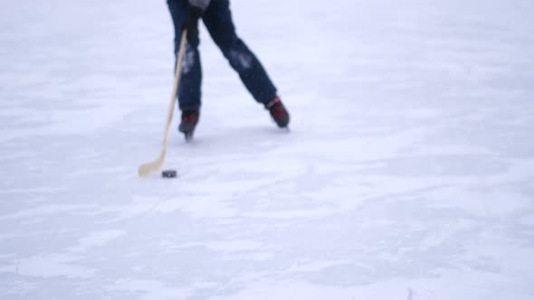 Kid Playing Hockey on a Frozen Ice