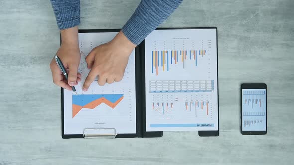 Businessman Analyze Financial Chart Of Company.