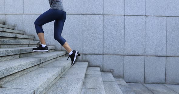 Fitness sports woman running up stairs in city alt