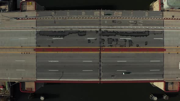 Aerial Birds Eye Overhead Top Down Ascending Shot Cars Driving on Multilane Road Bridge Over Water alt