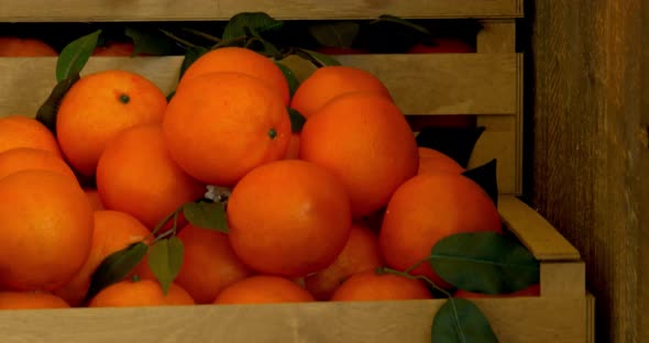 Raw Oranges In Rustic Wooden Box.