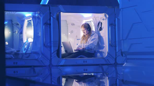 Teenage Girl is Spending Time in a Guest Room of a Pod Hotel alt