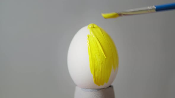 Yellow colored egg on a gray background. Easter
