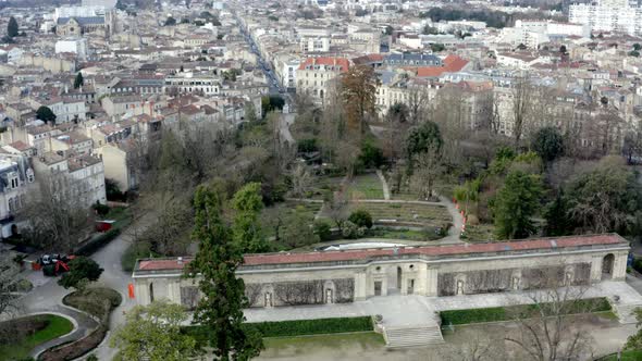Botanical garden of Bordeaux, France with central long gate building, Aerial right pan reveal alt