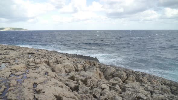 Geyser of Water Splashes near Coral Lagoon Cave in Malta in Wintertime alt