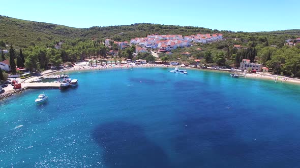 Aerial view of blue bay with apartments on hill and beach, Sukosan, Croatia alt