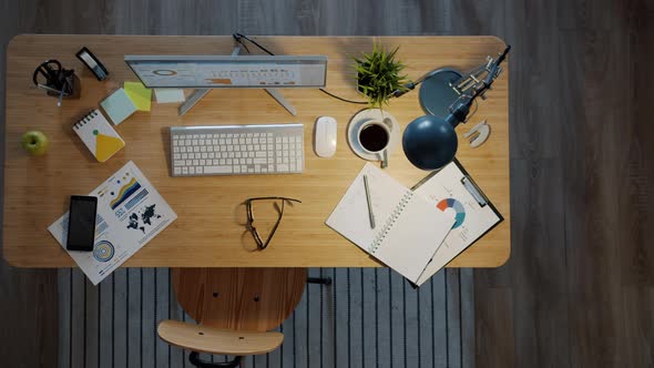 Top View of Desk in Office with Computer and Business Papers and No People alt
