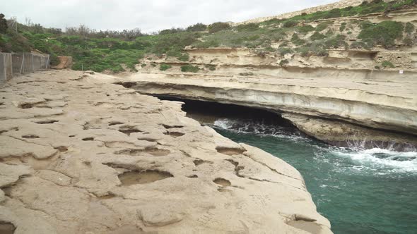 St Peters Pool Stone Beach Cave with Nobody Around Just Some Scarce Greenery on Hill alt