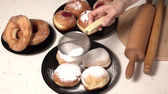 Spreading Sugar Powder On Hanukkah Doughnuts