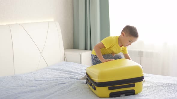 Cute Baby Trying To Open a Suitcase at Home in the Room alt