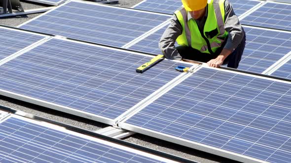 Male worker working at solar station 4k alt