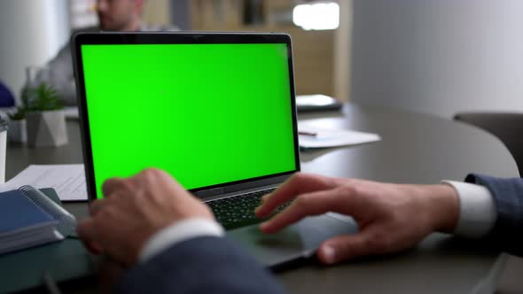 Business Man Using Touchpad Laptop Green Screen on Corporate Team Conference alt