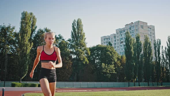Closeup Sunny Portrait of a Professional Jogging Blonde Girl alt