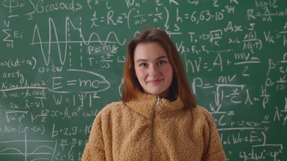 Portrait of Happy Young Woman Student Standing in Class with Arms Crossed Smiling Looking at Camera alt