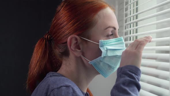 An Isolated Woman Is Looking Out the Window. alt