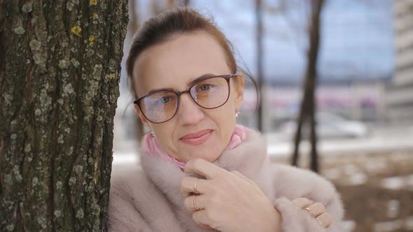 Portrait of Middleaged Women in Winter Park Near the Tree alt