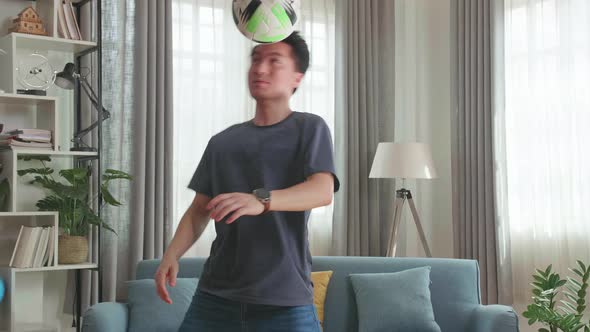 Asian Man Show Skill With Soccer Ball In Living Room, Soccer Freestyle alt
