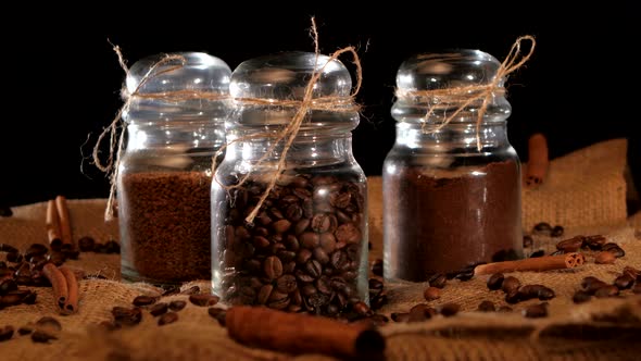 Three Bottles of Different Coffee Inside on Black Background alt