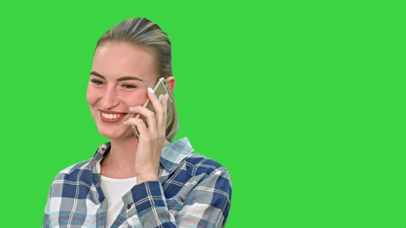 Pretty Woman in Casual Clothes Talking on the Phone and Smiling on a Green Screen, Chroma Key. alt